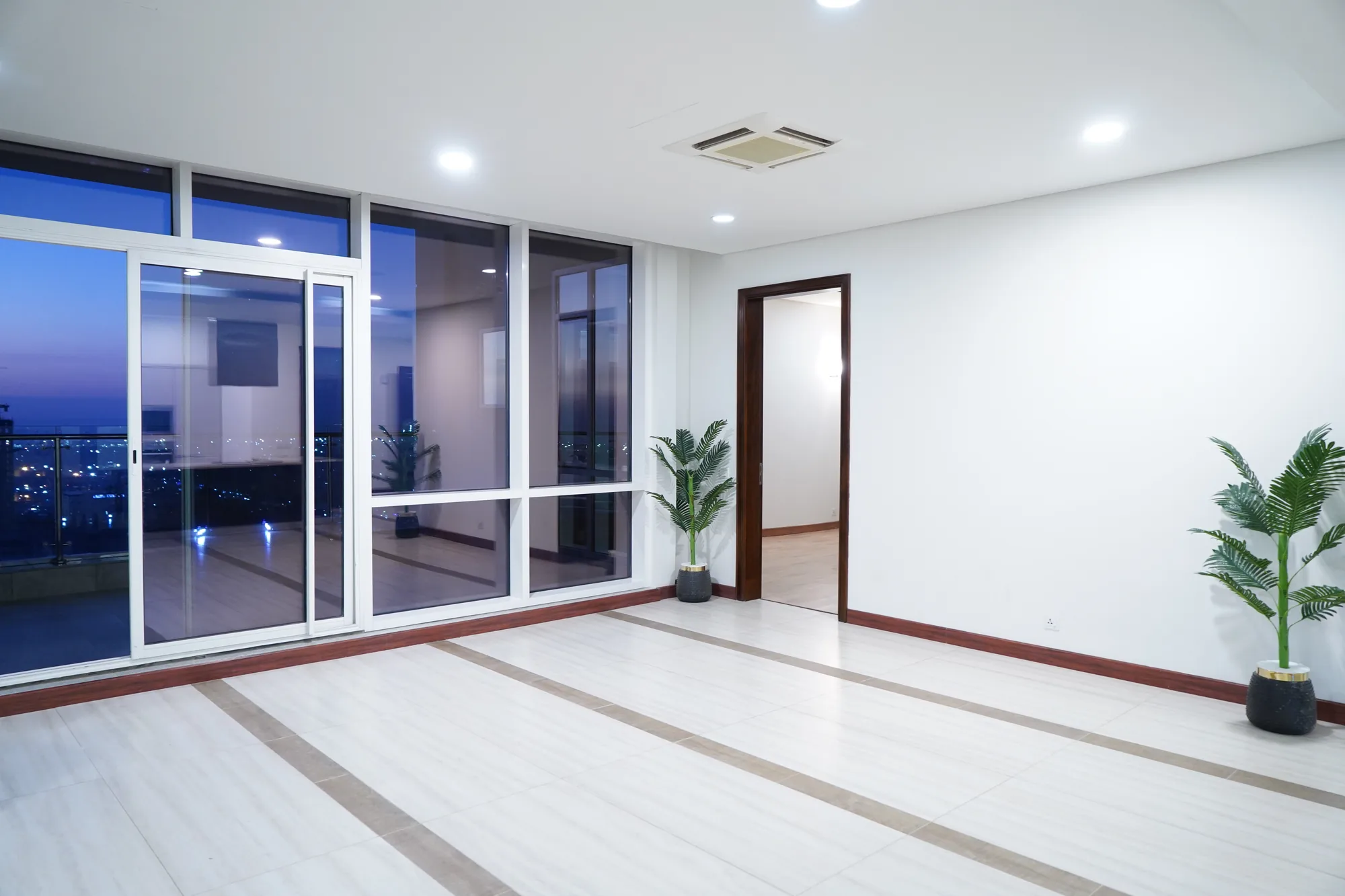 Finished interior with evening city view at Summit Tower